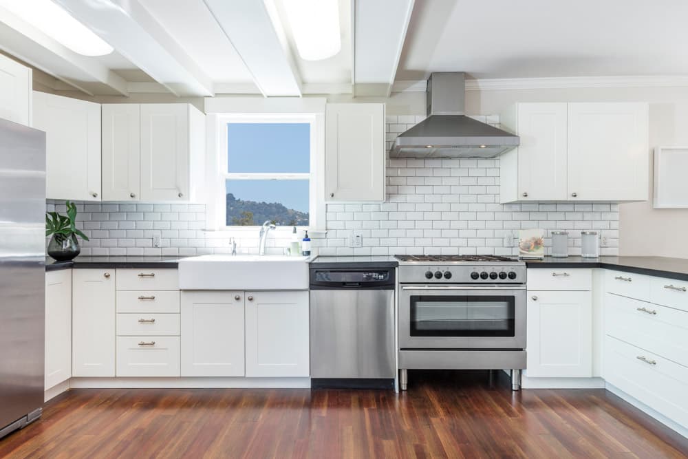 A clean home kitchen with visible sink and plumbing fixtures.